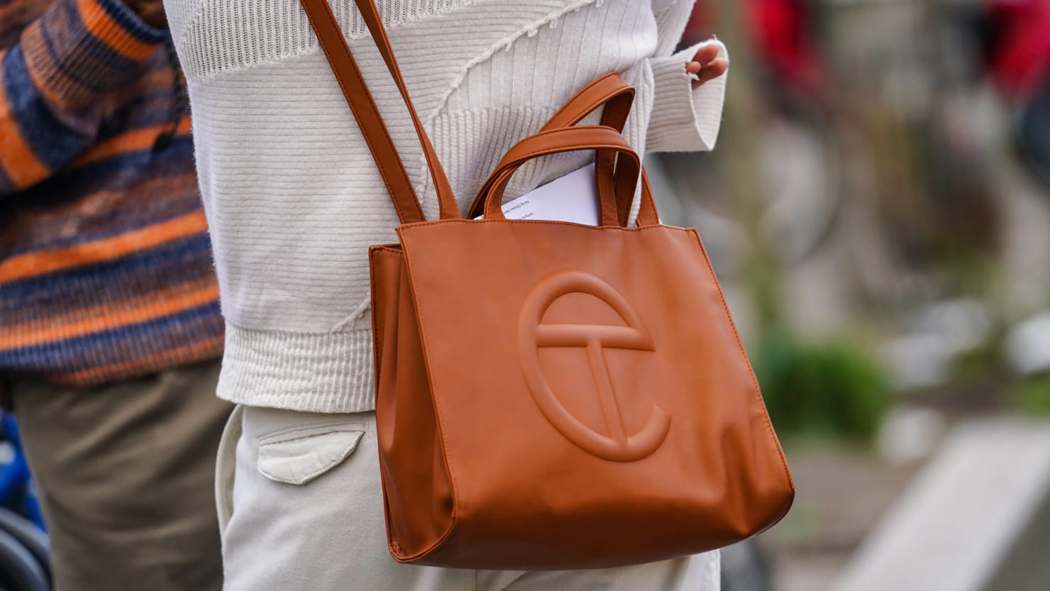 a person wear brown Telfar bag