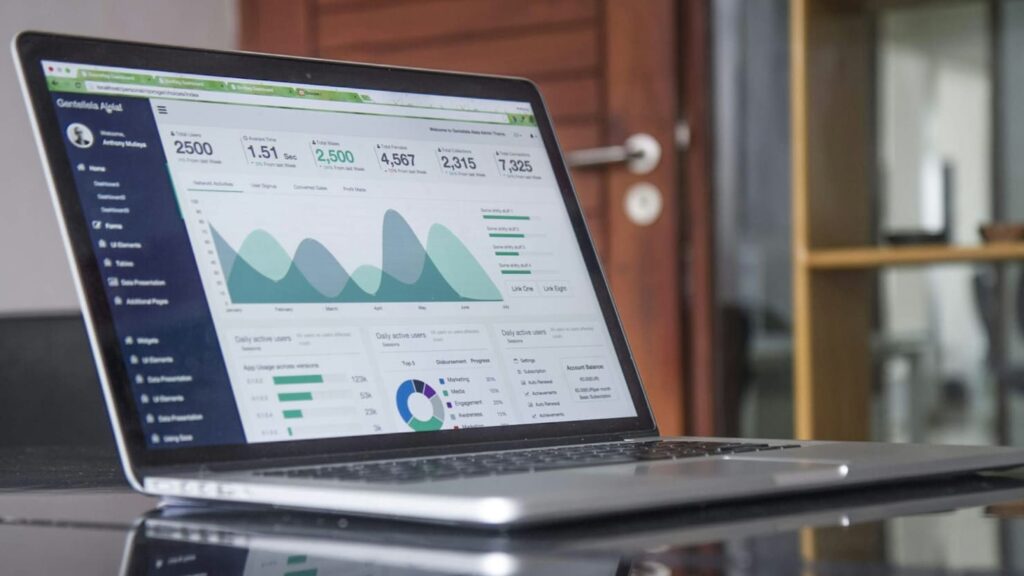 laptop with marketing data on desk