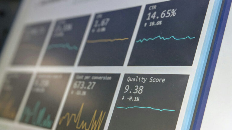 laptop screen shows performance marketing data