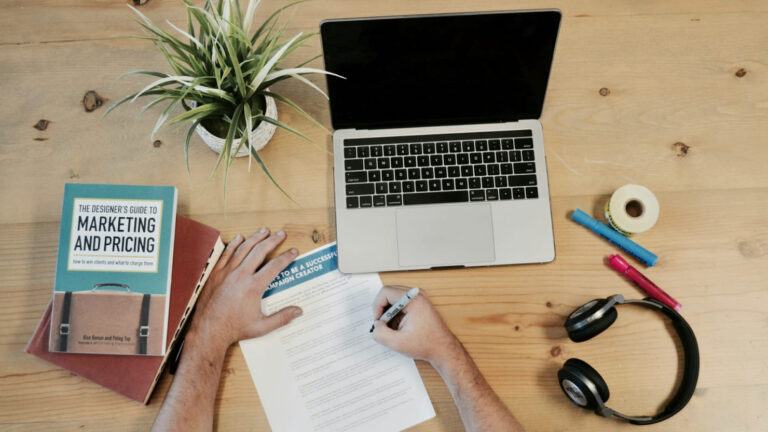 person writing about npp marketing with laptop open