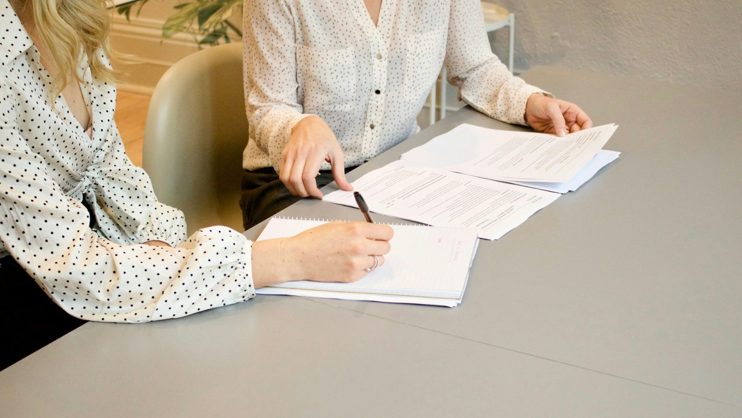 people signing documents